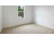 Cozy bedroom with neutral carpet, a window with natural light and ample wall space at 1747 Carnelian St, Deland, FL 32720