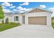 Charming single-Gathering home with a well-manicured lawn and a two-car garage, freshly painted with attractive exterior at 1747 Carnelian St, Deland, FL 32720