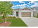 Single-Gathering home with lush landscaping, manicured lawn, and a neutral color scheme, featuring a two-car garage at 1747 Carnelian St, Deland, FL 32720