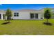 The backyard has a lush green lawn and a pristine exterior at 1749 Carnelian St, Deland, FL 32720