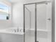 Bathroom showcasing a glass-enclosed shower and soaking tub at 1749 Carnelian St, Deland, FL 32720