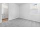 Bright bedroom with neutral carpet and walls, with en-suite bathroom at 1749 Carnelian St, Deland, FL 32720