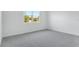 Bright bedroom features neutral carpet and walls, with a large window for natural light at 1749 Carnelian St, Deland, FL 32720