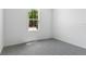 Bedroom with plush gray carpeting, neutral walls, and bright natural light from a large window at 1749 Carnelian St, Deland, FL 32720