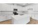 Bright kitchen with white cabinets, quartz countertops, stainless steel appliances, and a center island with a sink at 1749 Carnelian St, Deland, FL 32720