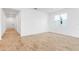 Spacious living room featuring wood-look tile floors, white walls, and lots of natural light from a large window at 1749 Carnelian St, Deland, FL 32720