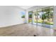 Living room with sliding glass doors leading to outdoor patio; wood-look tile floors and bright neutral walls at 1749 Carnelian St, Deland, FL 32720