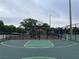 View of basketball court with basketball hoop, playground, and chain link fence at 1750 Saint Tropez Ct, Kissimmee, FL 34744