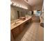 Bathroom featuring double sinks and a large mirror with vanity lighting at 1750 Saint Tropez Ct, Kissimmee, FL 34744