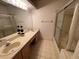 Bathroom featuring double sinks and a glass shower at 1750 Saint Tropez Ct, Kissimmee, FL 34744