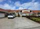 Inviting home with lush landscaping, a spacious driveway, and a classic tile roof at 1750 Saint Tropez Ct, Kissimmee, FL 34744