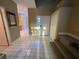 Bright foyer with white tile flooring, staircase and a glimpse into the kitchen at 1750 Saint Tropez Ct, Kissimmee, FL 34744
