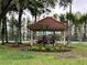 Charming gazebo surrounded by lush greenery, providing a peaceful spot for relaxation and reflection at 1750 Saint Tropez Ct, Kissimmee, FL 34744