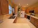 Well-lit kitchen with white appliances, oak cabinets and light countertops at 1750 Saint Tropez Ct, Kissimmee, FL 34744