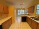 Efficient kitchen featuring oak cabinets, white countertops, and tile flooring at 1750 Saint Tropez Ct, Kissimmee, FL 34744