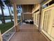 Enclosed patio with tile floors and a ceiling fan offers serene water views, perfect for relaxing outdoors at 1750 Saint Tropez Ct, Kissimmee, FL 34744