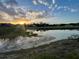 Beautiful sunset view overlooking the pond, houses, and golf course in the community at 1750 Saint Tropez Ct, Kissimmee, FL 34744
