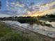 Sunset view overlooking the pond, houses, and golf course in the community from a different vantage point at 1750 Saint Tropez Ct, Kissimmee, FL 34744