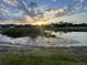 Beautiful view of the lake reflecting a radiant sunset, enhancing the community's appeal at 1750 Saint Tropez Ct, Kissimmee, FL 34744