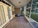 Screened porch featuring tile flooring and clear view of the community landscaping and waterway at 1750 Saint Tropez Ct, Kissimmee, FL 34744