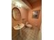 Charming powder room featuring a pedestal sink, oval mirror, and decorative accents at 1750 Saint Tropez Ct, Kissimmee, FL 34744