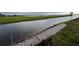 Waterfront view of the canal featuring a brick path, providing scenic access and a relaxing atmosphere at 1750 Saint Tropez Ct, Kissimmee, FL 34744