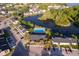 Aerial view of a condo complex with a pool, parking and pond, surrounded by mature trees at 2031 Ludlow Ln # 3303, Orlando, FL 32839