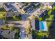 Birds eye view of the condo community with a swimming pool and pond nestled within a serene, tree-lined neighborhood at 2031 Ludlow Ln # 3303, Orlando, FL 32839