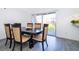 Dining area with wood table, chairs, gray flooring, and sliding glass doors to the outdoors at 2031 Ludlow Ln # 3303, Orlando, FL 32839