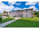 Exterior of a multi-Gathering home with manicured lawn and sidewalks at 2031 Ludlow Ln # 3303, Orlando, FL 32839