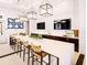 Stylish bar area with a long counter, modern lighting, a sink, and wall-mounted TVs for entertainment at 2057 Celebration Blvd, Celebration, FL 34747