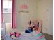 Charming bedroom with princess decor, pink accents, and playful stuffed animals at 2057 Celebration Blvd, Celebration, FL 34747