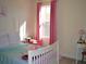 Cozy bedroom with soft pink curtains, white furniture, and a comfortable bed at 2057 Celebration Blvd, Celebration, FL 34747
