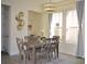 Dining room with a grey wood table set, a modern chandelier, and lots of light from the windows at 2057 Celebration Blvd, Celebration, FL 34747