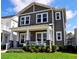 Inviting two-story home boasts a charming front porch with elegant columns and lush green lawn at 2057 Celebration Blvd, Celebration, FL 34747