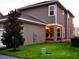 Charming home exterior with a covered patio featuring cozy seating and a well-manicured lawn at 2057 Celebration Blvd, Celebration, FL 34747