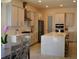 Modern white kitchen with updated stainless steel appliances, cabinetry, and a view to the dining room at 2057 Celebration Blvd, Celebration, FL 34747