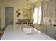 Modern kitchen with a view to the dining room, featuring a kitchen island, and white cabinets at 2057 Celebration Blvd, Celebration, FL 34747