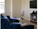 Cozy living room features comfortable blue sofa, entertainment center, and natural light at 2057 Celebration Blvd, Celebration, FL 34747