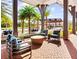 Outdoor patio with comfortable seating, a built-in grill, and beautiful views of lush landscaping and palm trees at 2057 Celebration Blvd, Celebration, FL 34747