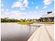 Scenic view of a tranquil pond reflecting the sky, bordered by lush greenery and community buildings at 2057 Celebration Blvd, Celebration, FL 34747