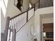 Elegant staircase with wood railings and white balusters, complemented by stylish decor and natural light at 2057 Celebration Blvd, Celebration, FL 34747