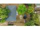 Aerial view of backyard featuring mature trees, trampoline, storage shed and perimeter fencing at 2081 N Normandy Blvd, Deltona, FL 32725