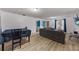 Well-lit living room featuring an open floor plan with wood floors and a gray sofa at 2081 N Normandy Blvd, Deltona, FL 32725