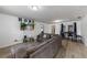 Bright living room with modern gray couch, wood floors, and a television set for entertainment at 2081 N Normandy Blvd, Deltona, FL 32725