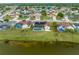 Aerial view of the home, screened pool, and the lake at 2322 Queenswood Cir, Kissimmee, FL 34743