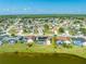 Stunning aerial view of homes near a lake, many featuring private pools and solar panels for energy efficiency at 2322 Queenswood Cir, Kissimmee, FL 34743