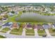 Aerial view of a residential neighborhood surrounding a lake, highlighting the subject property with a pin at 2322 Queenswood Cir, Kissimmee, FL 34743