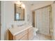 Clean and functional bathroom featuring a single sink vanity, tile flooring, and a shower with a patterned curtain at 2322 Queenswood Cir, Kissimmee, FL 34743
