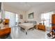 Bright bedroom featuring tile floors, natural light, and access to the outdoor patio at 2322 Queenswood Cir, Kissimmee, FL 34743